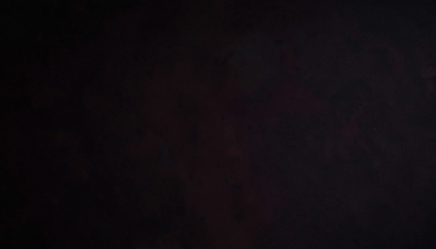 Dark textured background with subtle maroon undertones, moody and refined